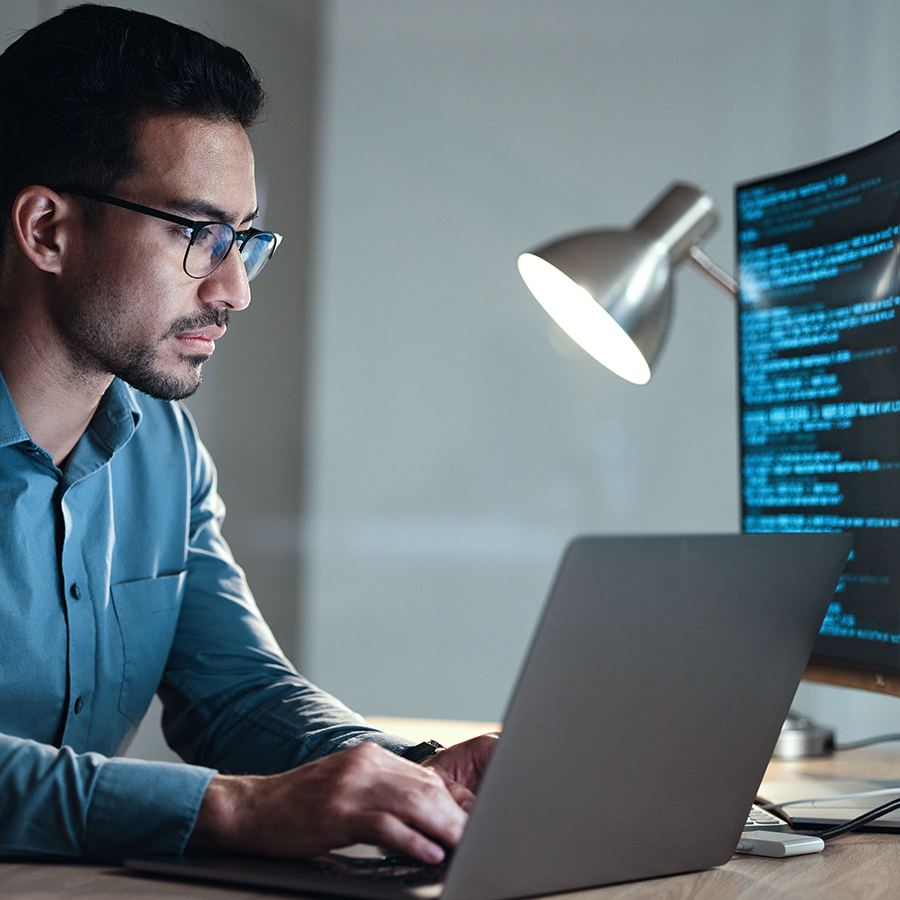 Man sitting at computer coding