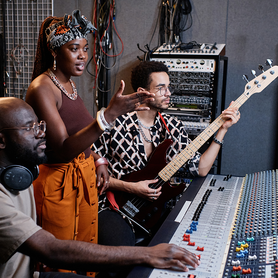 2 musicians collaborating with the recording engineer