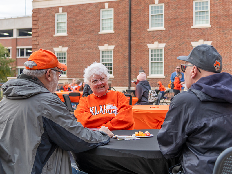 2023 homecoming reunion event tables on the patio with people chatting