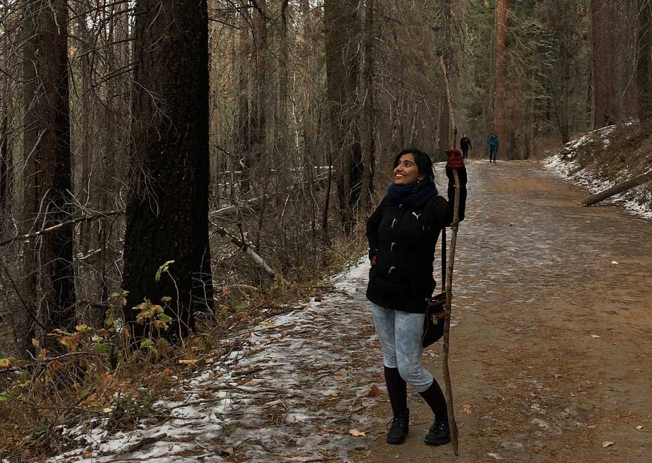 Rittika Shamsuddin walking through the woods