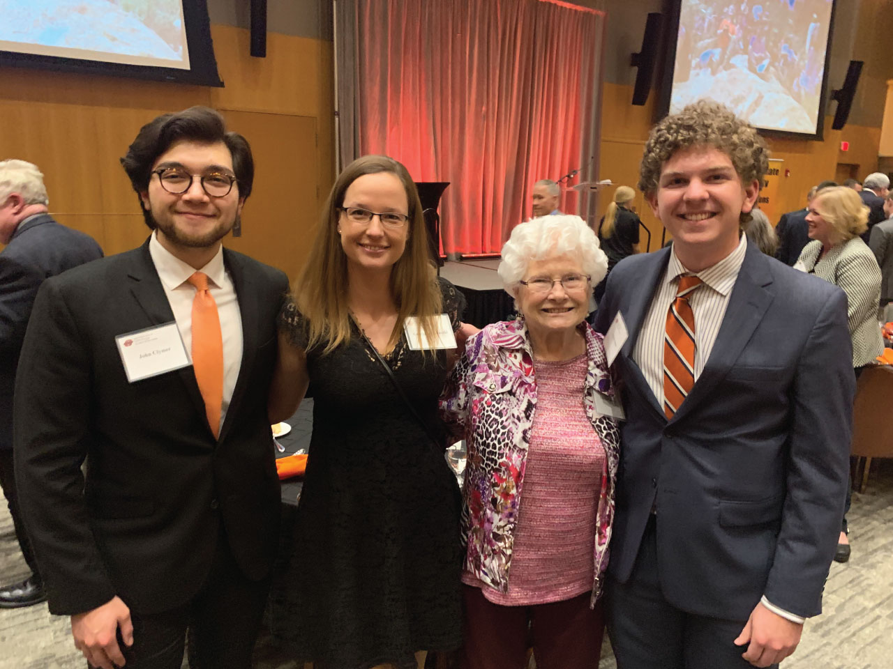 Three students and a donor at an awards banquet. Three students and a donor at an awards banquet.