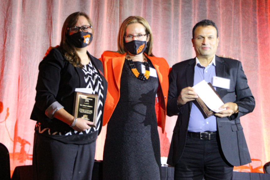 Dr. Ashley Burkett, Dr. Camelia Knapp and Dr. Ahmed Ismail posing on stage for a group photo Dr. Ashley Burkett, Dr. Camelia Knapp and Dr. Ahmed Ismail posing on stage for a group photo.