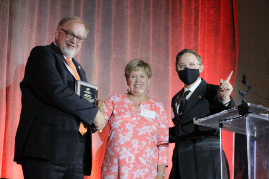 Mr. Rick Fritz, Mrs. Patty Walker and Mr. John Fields posing on stage for a group photo. Mr. Rick Fritz, Mrs. Patty Walker and Mr. John Fields posing on stage for a group photo.