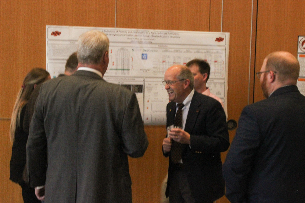 Dr. Jim Puckette laughing with students before banquet. Dr. Jim Puckette laughing with students before banquet.