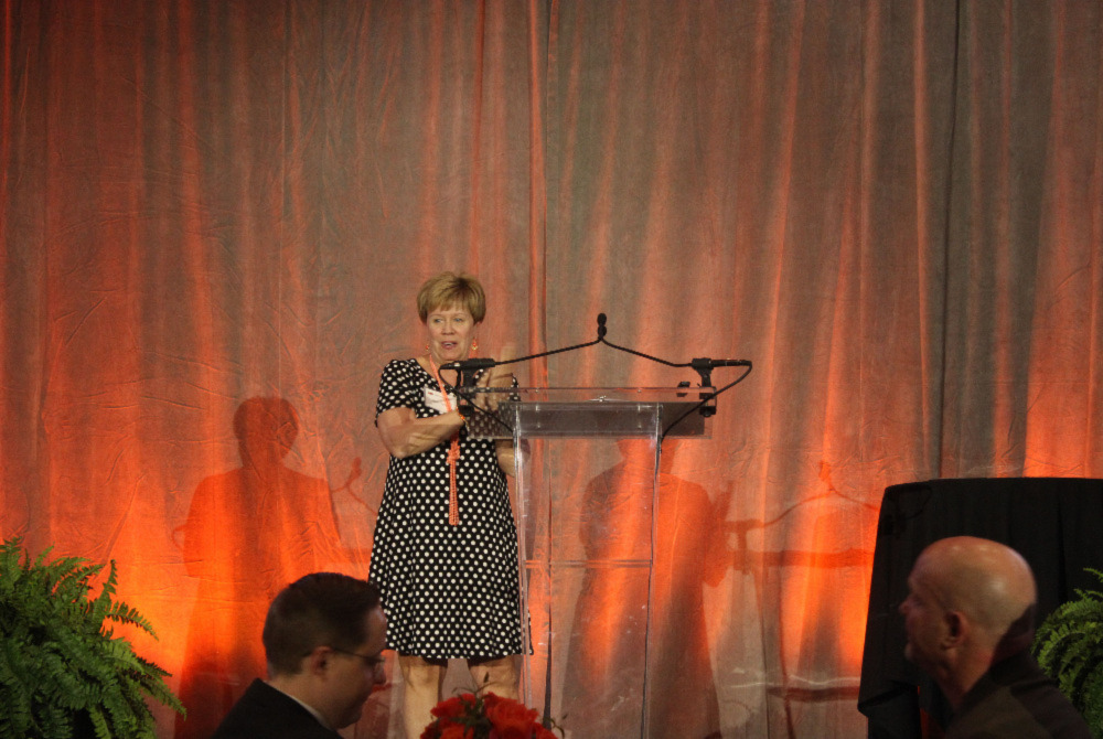 Mrs. Patty Walker at a podium announcing award winners. Mrs. Patty Walker at a podium announcing award winners.