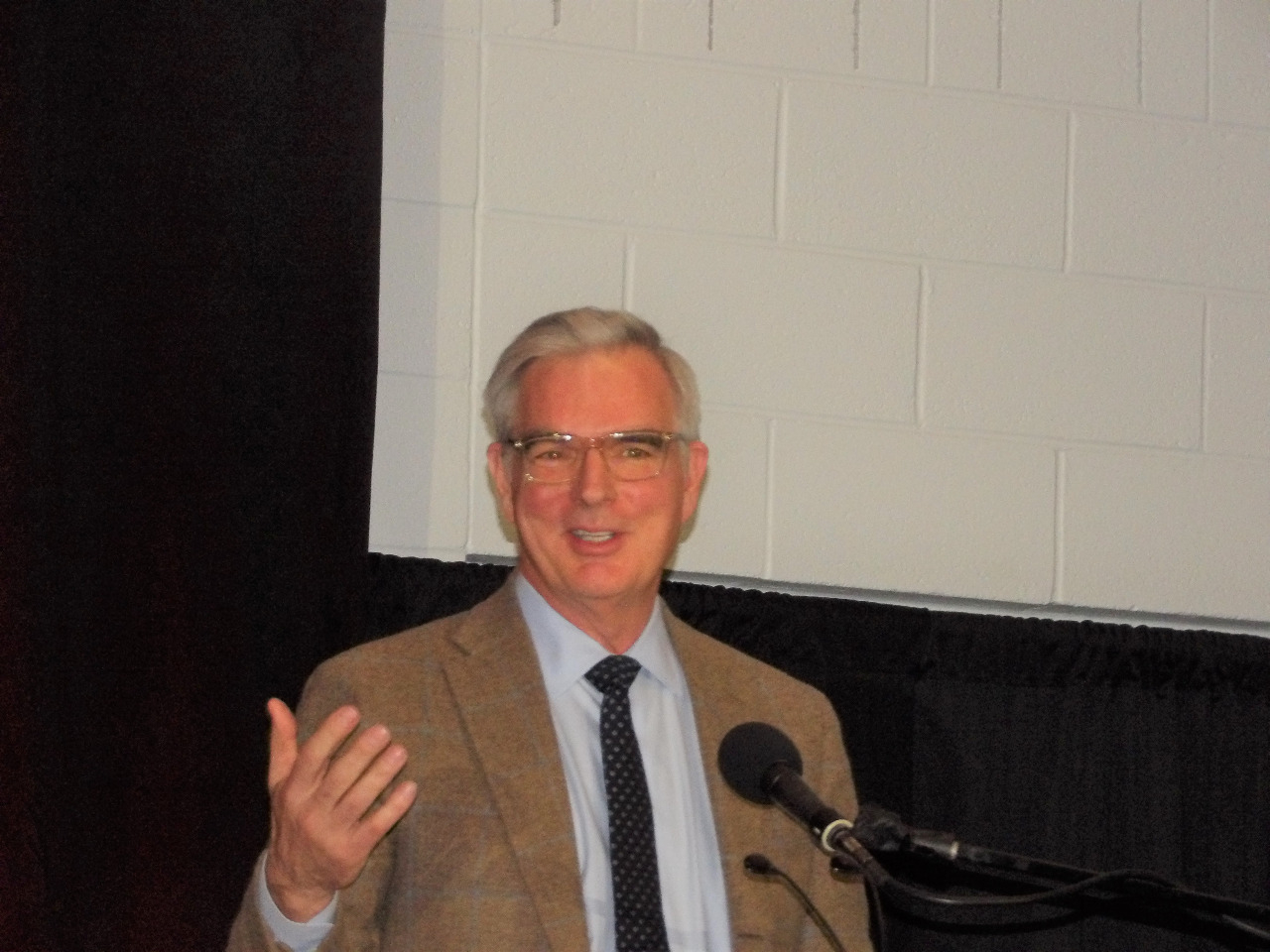 Dr. Erik Oswald at podium making a speech. Dr. Erik Oswald at podium making a speech.