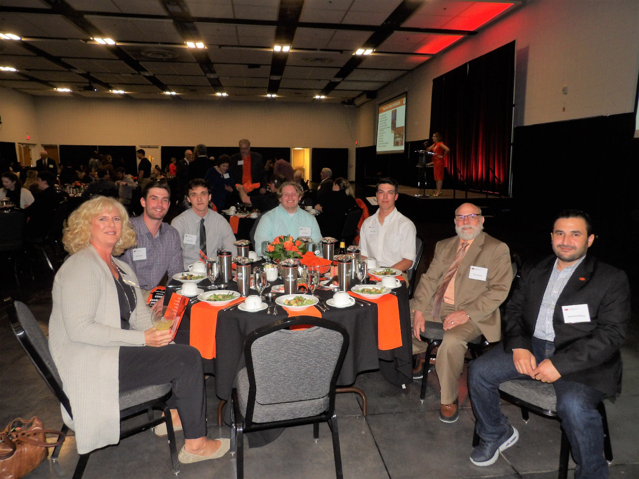 Dr. Jack Pashin visiting with five male students and a students mother at the banquet dinner table. Dr. Jack Pashin visiting with five male students and a students mother at the banquet dinner table.