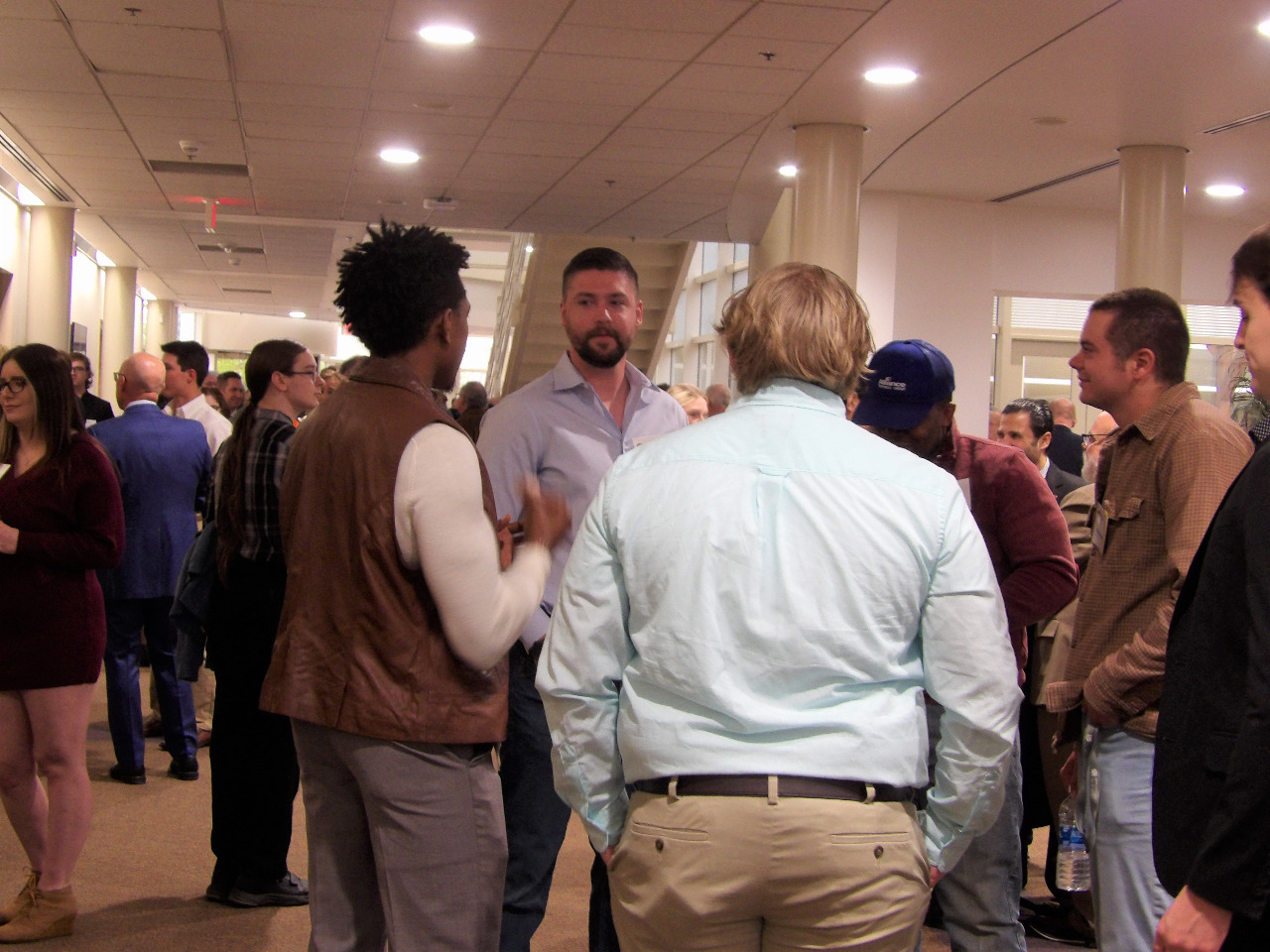 Room full of people visiting before banquet begins. Room full of people visiting before banquet begins.