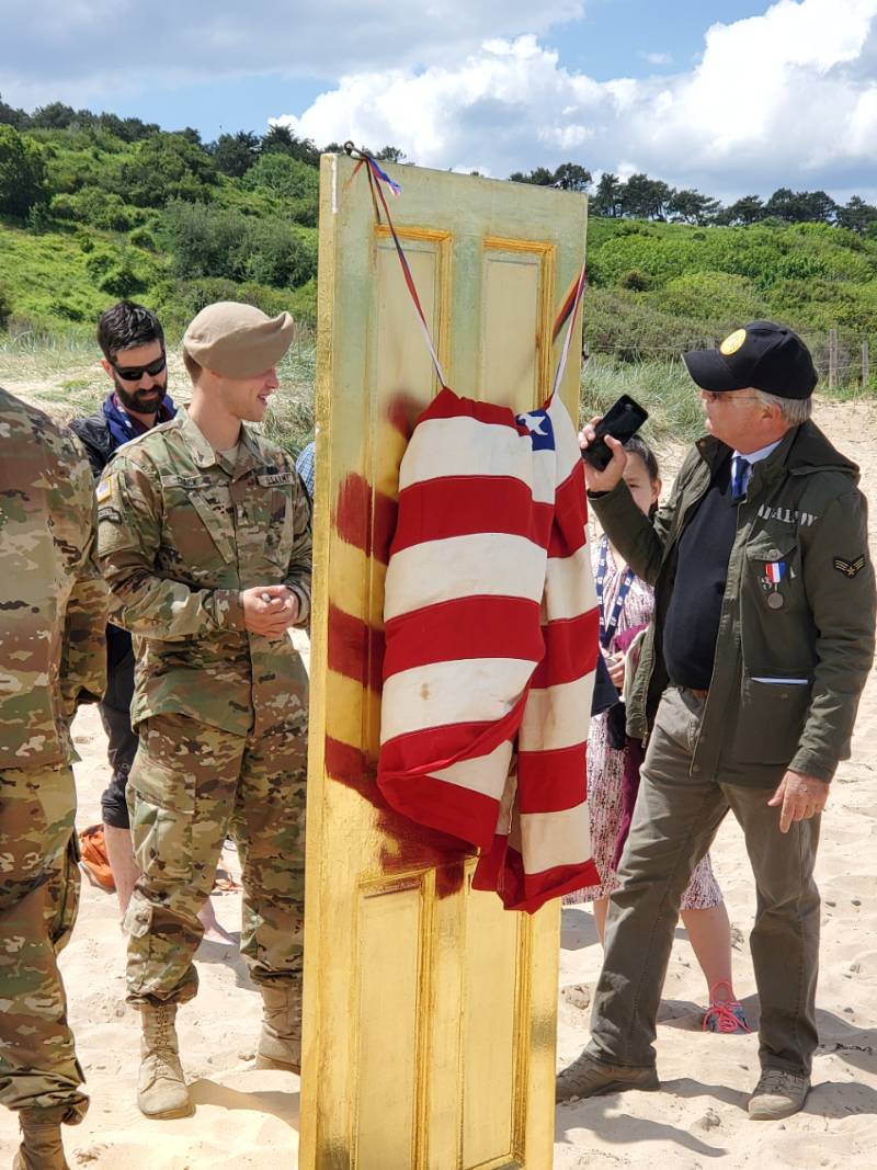 American flag with military on beach