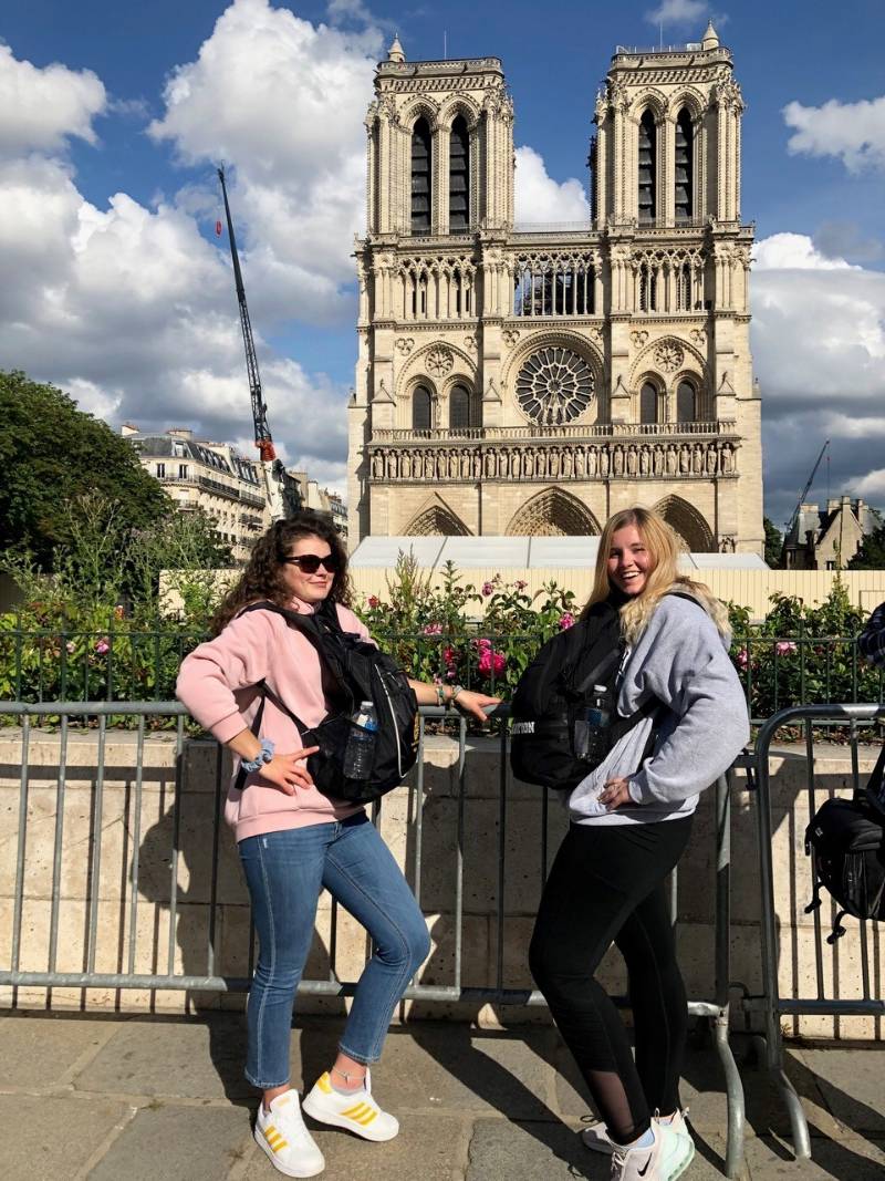 Two students standing in front of a building
