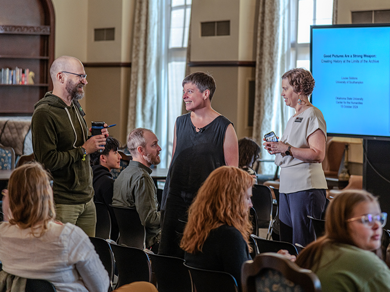 Louise Siddons speaking with a man and woman