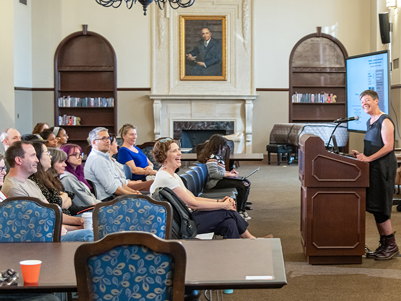 Louise Siddons presenting and smiling at audience