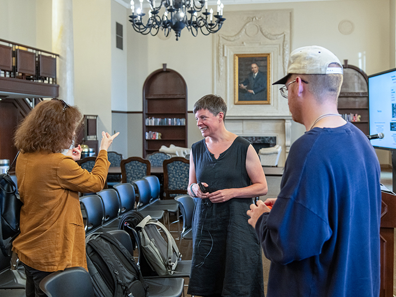 Louise Siddons visiting with a man and woman