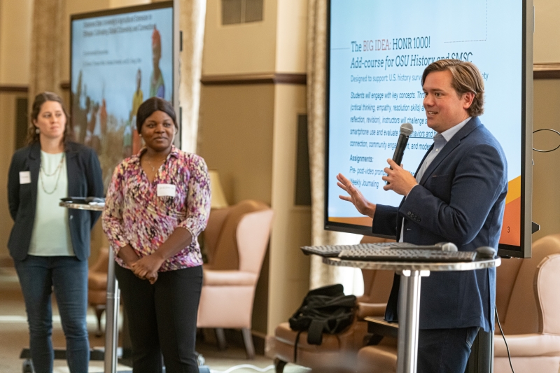 Dr. Andrew Abernathy speaking into a microphone