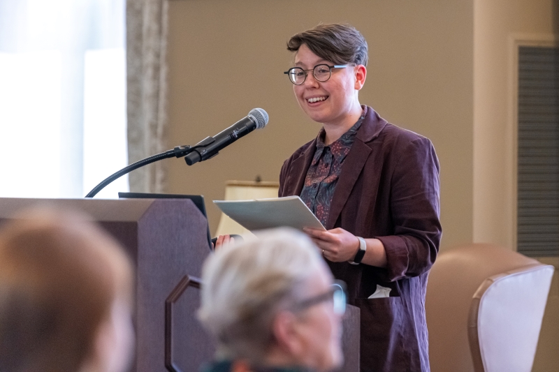 image is of Doyle at a podium