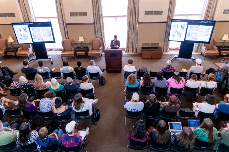Balcony view of Doyle presenting to an audience