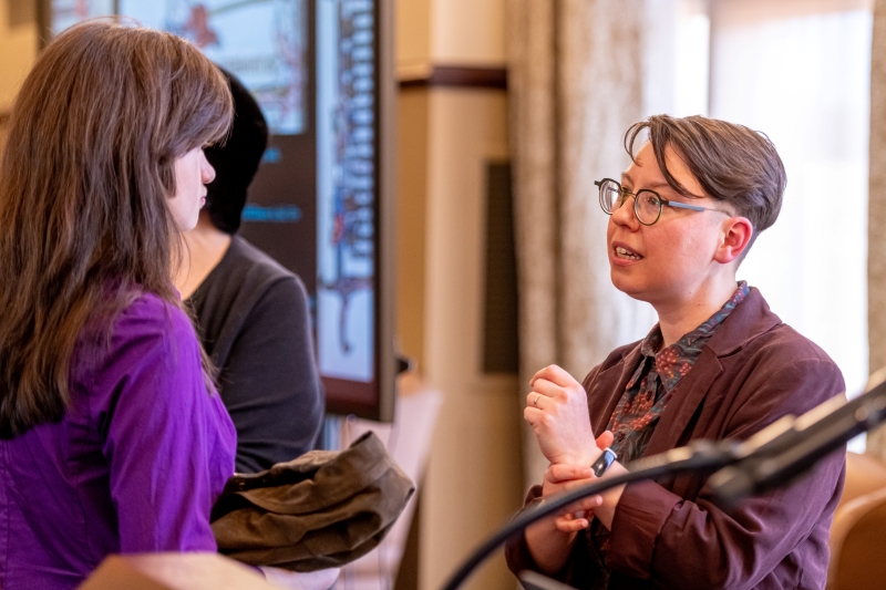 Doyle speaking with a student