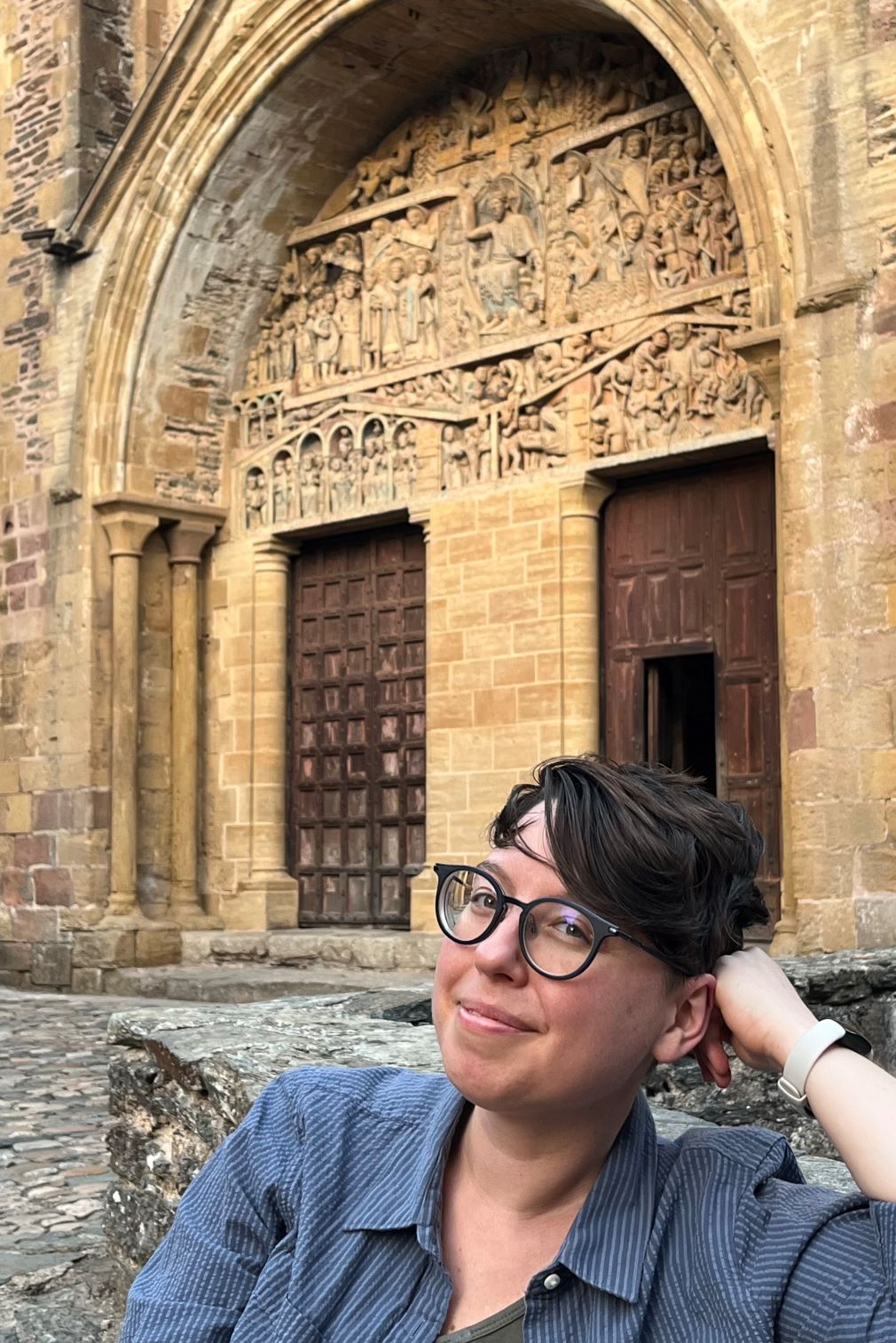 image is of scholar maeve doyle seated in front of an old building