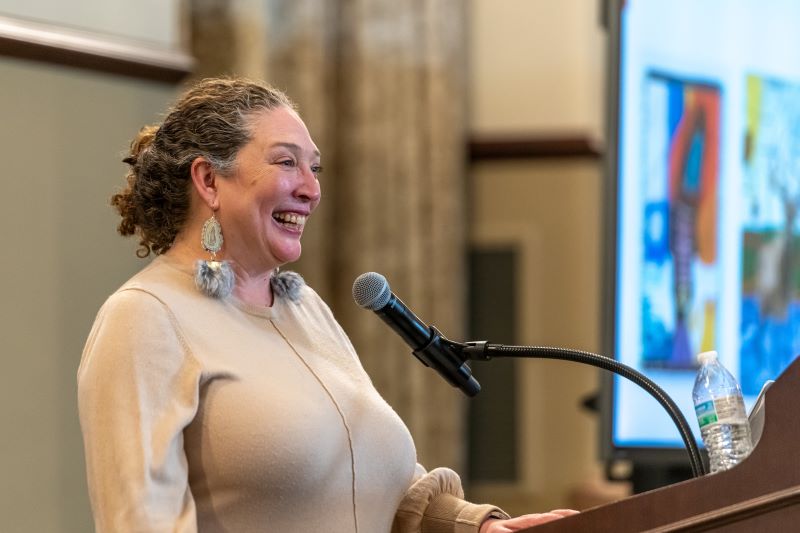 mishuana goeman smiling at the podium