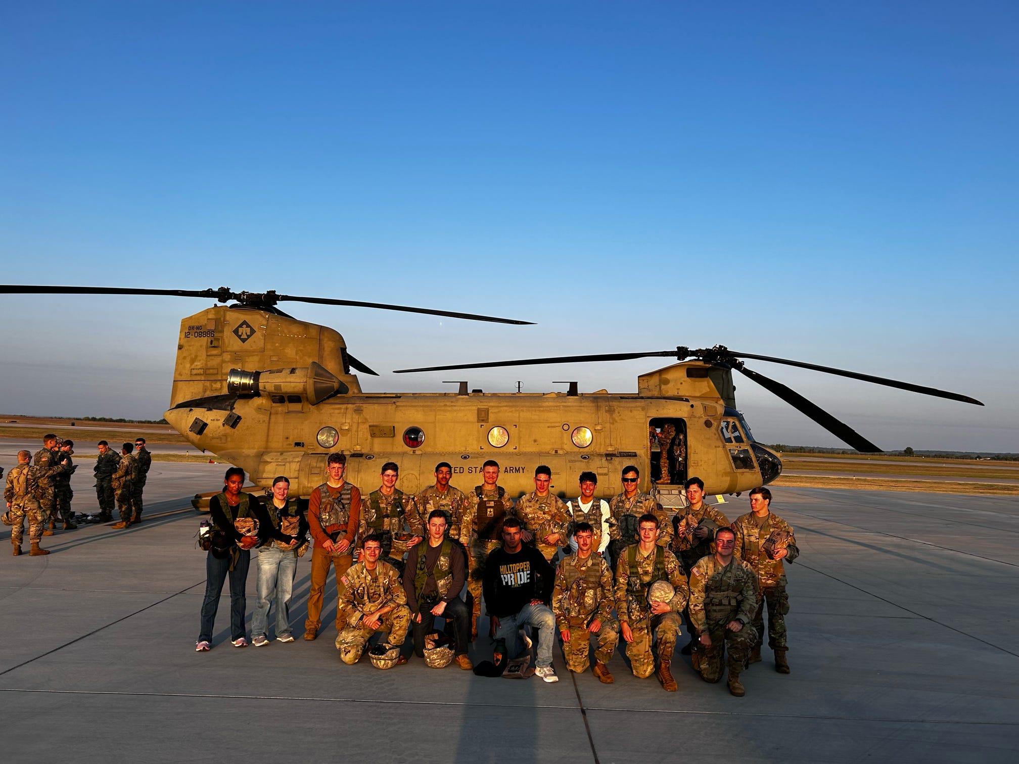cadets posing in front of helicopter