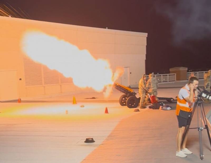 a cadet fires a canon at a football game