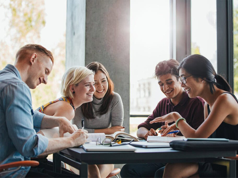 Group of students at a table having a discussion