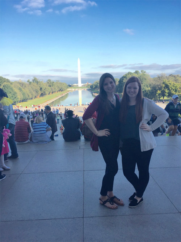 Two female students in front of the reflecting pool in Washington DC at the International Society of Paediatric Oncology Conference