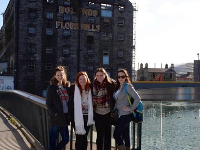 Four females outside old flour mill at the International Society of Paediatric Oncology Conference