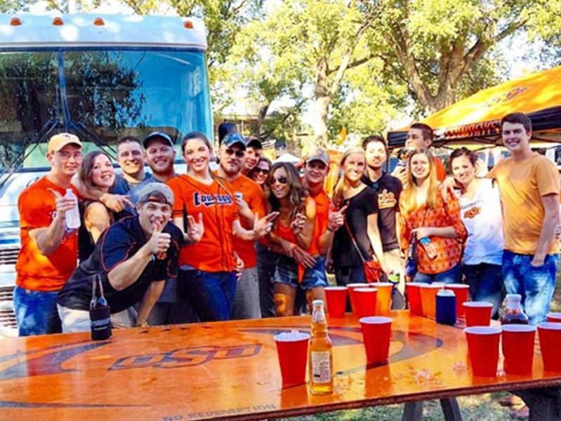Group of students with arms around each other smiling at camera