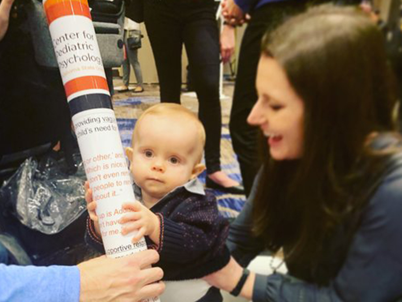 Baby helping mama at the Society of Pediatric Psychology Annual Conference