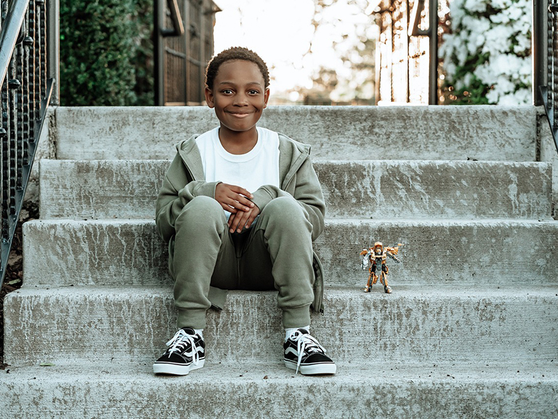 African-American boy sitting outside on steps