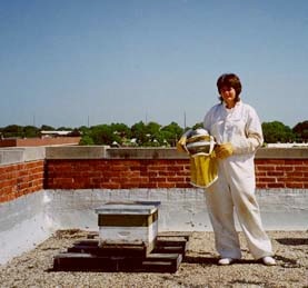 Woman posing in a protective bee collection suit