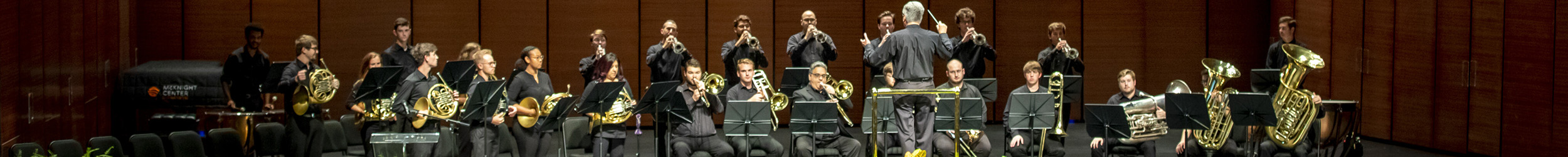 American flags on the ground in front of a campus library.